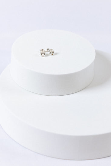 Sterling Silver Puff Mariner Stud Earrings on white display props with white background