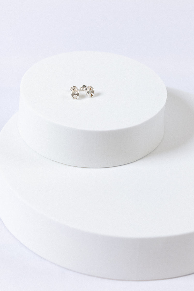 Sterling Silver Puff Mariner Stud Earrings on white display props with white background