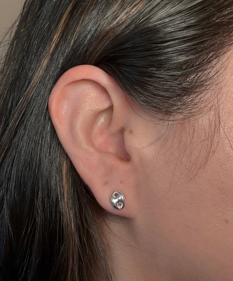 Close up of puff mariner stud earring in sterling silver